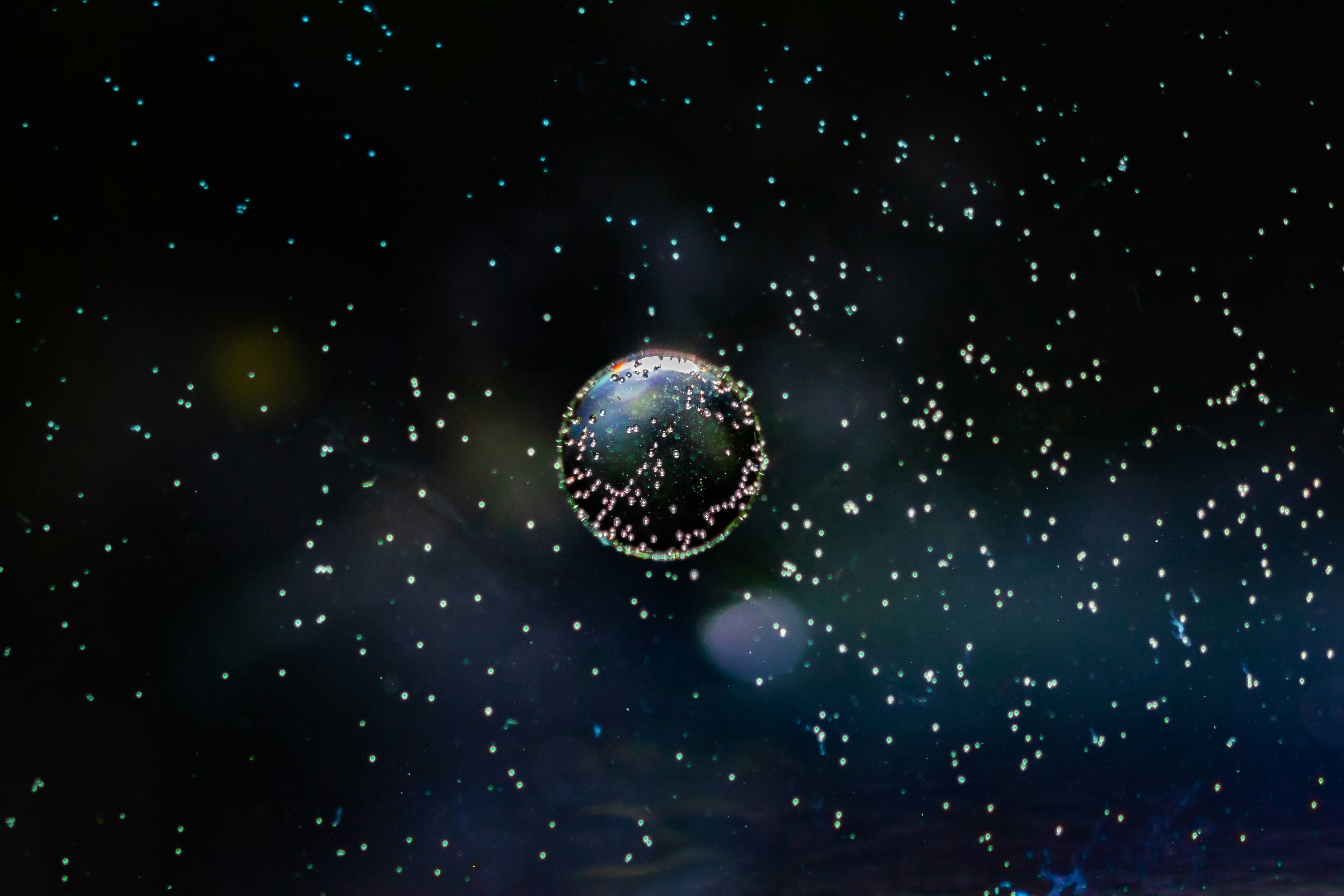 An image of the Earth in space surrounded by small dots, by Kai Dahms