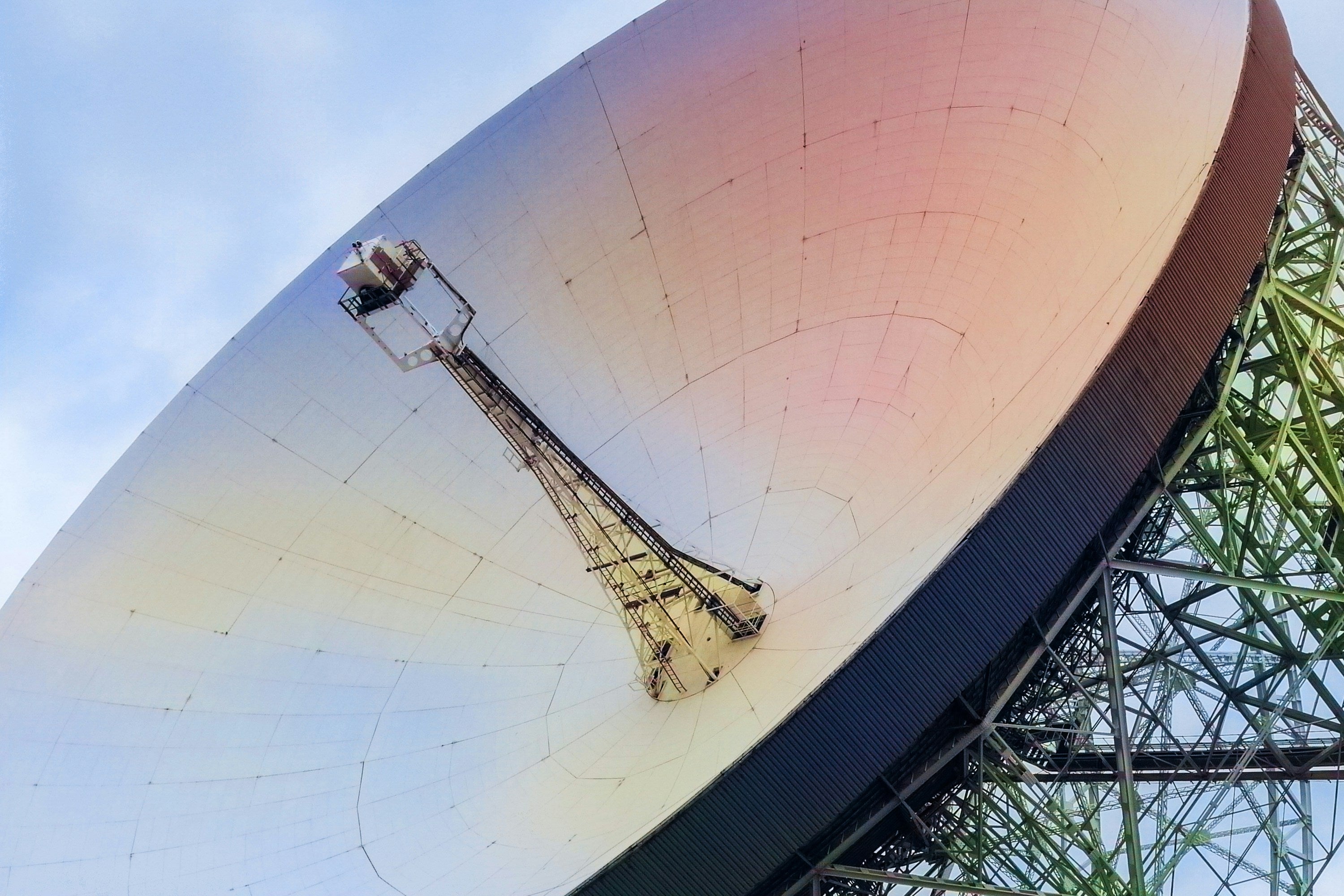 Image of a satellite dish against a blue sky, by Gavin Allanwood