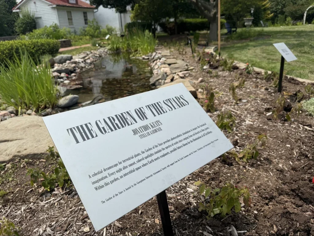 A plaque reads The Garden of the Stars in a garden at the Hayden Observatory.